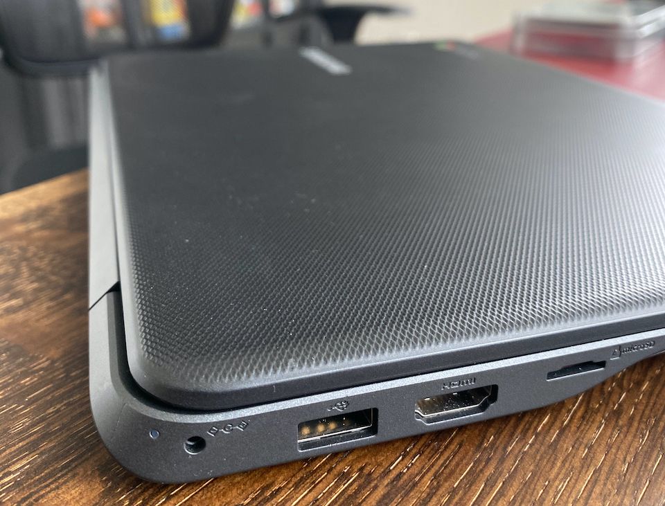 side view of the laptop with round charging connector